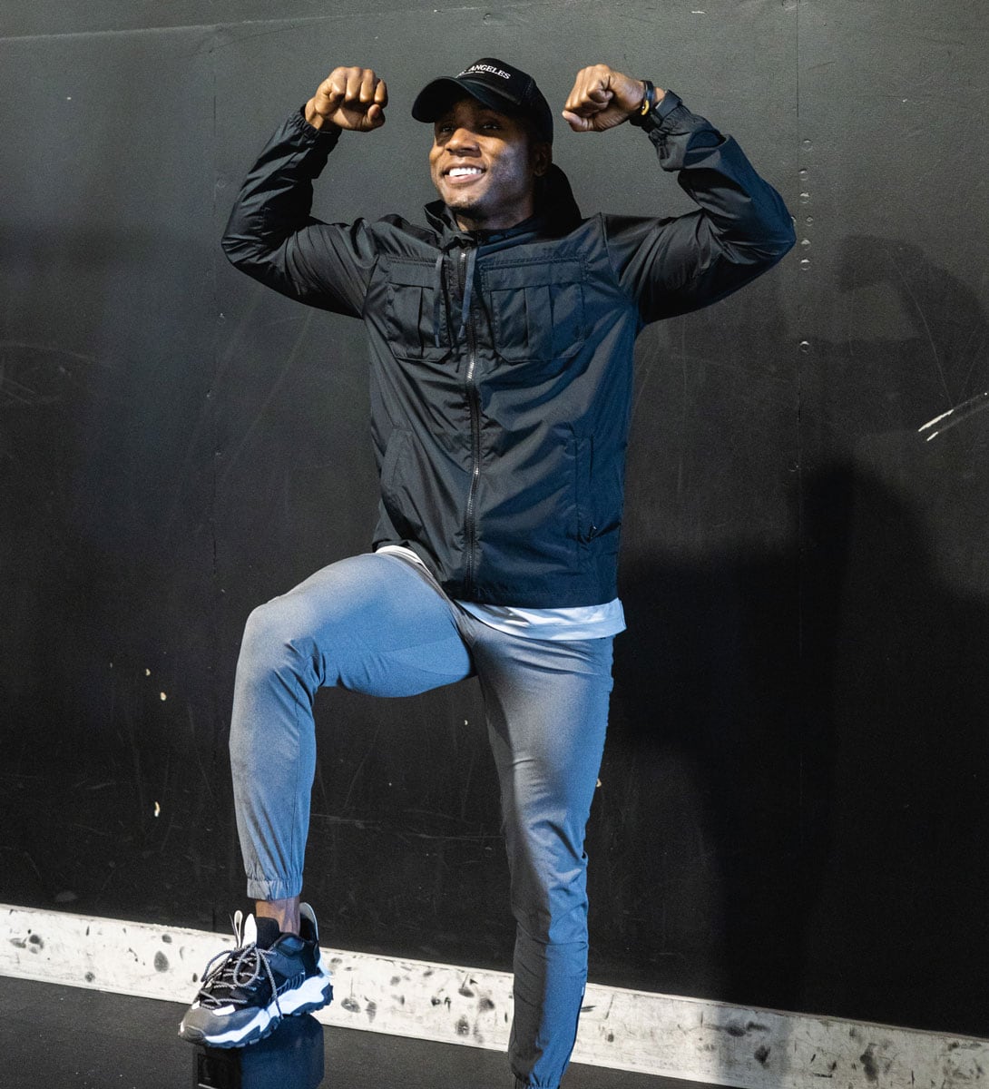 The coach is flexing his arms in the gym.